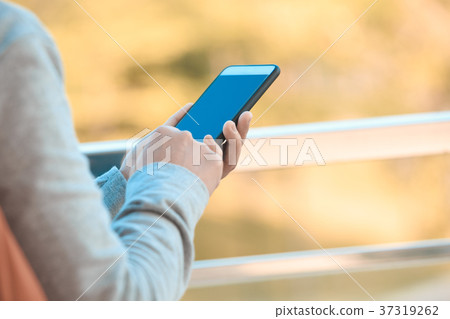 closeup of hands using smartphone outdoor 37319262