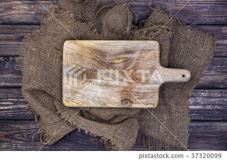 Wooden table with burlap cloth and cutting board Wooden table with burlap cloth and cutting board 37320099