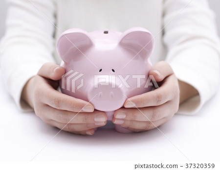 Piggy bank protected by hands Piggy bank protected by hands 37320359