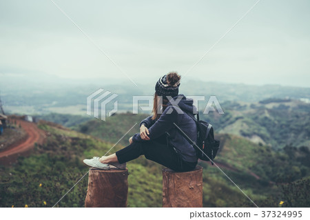 Young woman traveler sitting and looking view Young woman traveler sitting and looking view 37324995