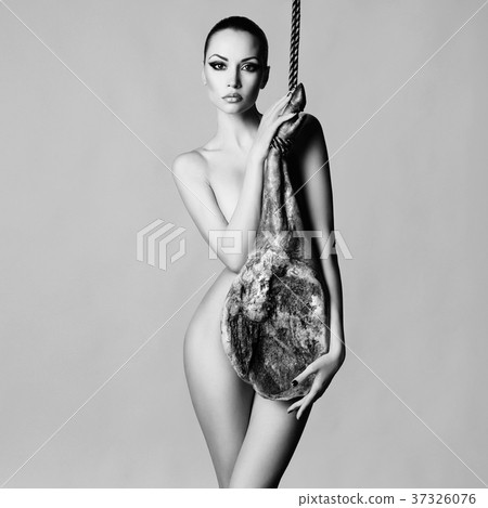 Nude elegant woman with Iberian jamon 37326076