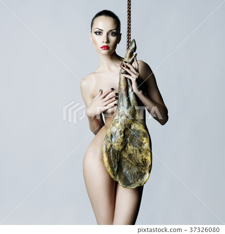Nude elegant woman with Iberian jamon 37326080
