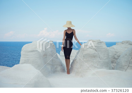 Lady in hat in an unusual landscape 37326120