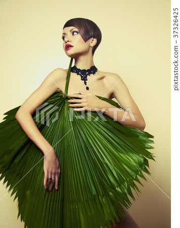 Beautiful lady with palm leaves 37326425