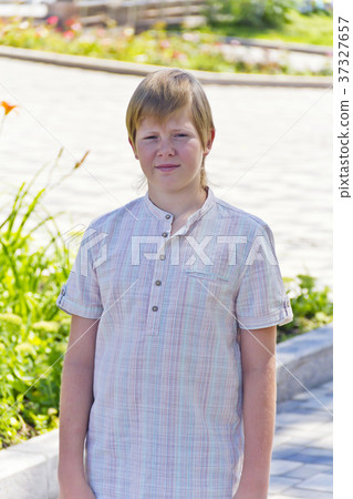 Portrait of serious boy in park Portrait of serious boy in park 37327657
