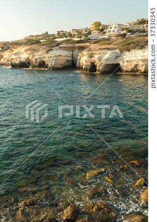 Sea caves formed by water at the coast of Cyprys 37330345