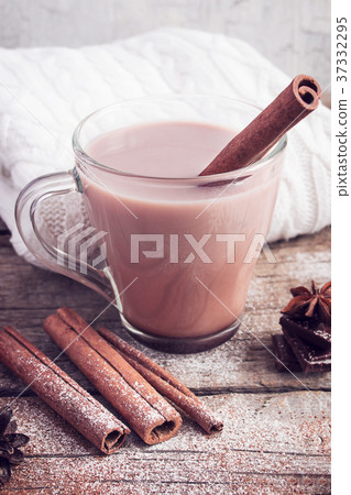 Hot cocoa with cinnamon sticks on white background Hot cocoa with cinnamon sticks on white background 37332295