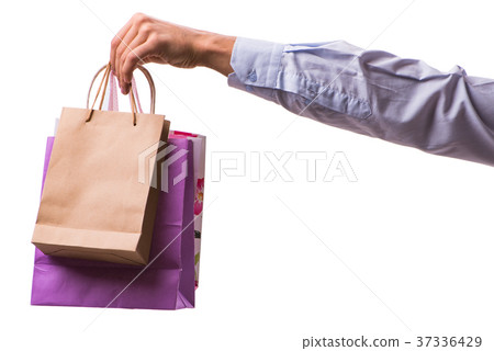Hand holding shopping bags with christmas shopping 37336429