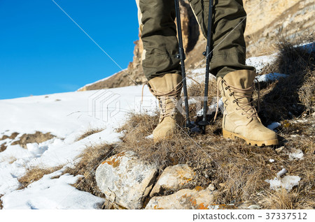 Close-up of a tourist's foot in trekking boots Close-up of a tourist's foot in trekking boots 37337512