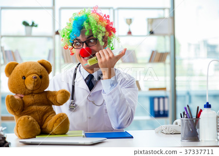 Funny pediatrician with toy in the hospital clinic Funny pediatrician with toy in the hospital clinic 37337711