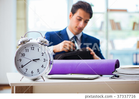 Man getting ready for sports break in the office Man getting ready for sports break in the office 37337716