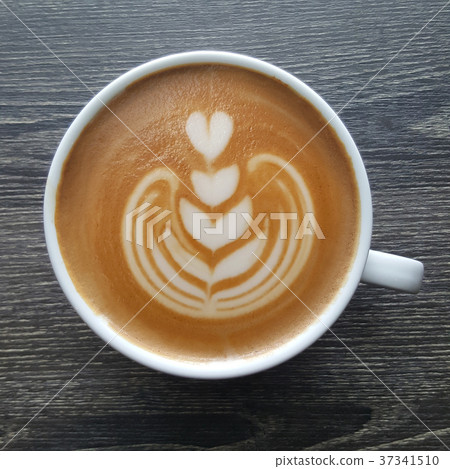 Top view of a mug of latte art coffee. Top view of a mug of latte art coffee. 37341510
