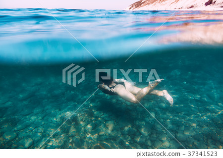 Slim woman dive underwater in blue sea 37341523
