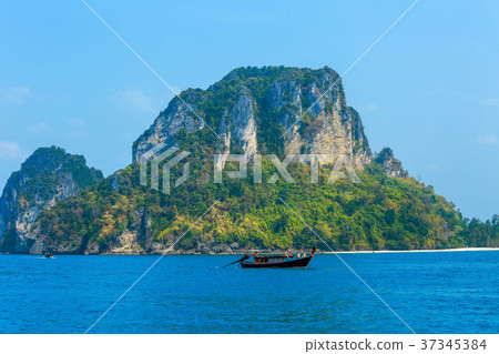 Long tail boat on the sea and rock, Krabi, Thailan Long tail boat on the sea and rock, Krabi, Thailan 37345384