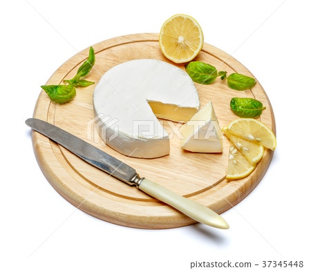 Round brie or camambert cheese on cutting board Round brie or camambert cheese on cutting board 37345448