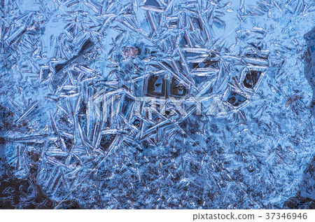The texture of the frozen blue ice, closeup 37346946