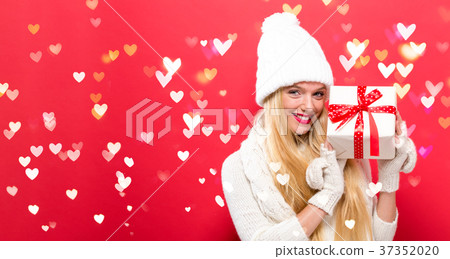 Young woman holding a gift Young woman holding a gift 37352020