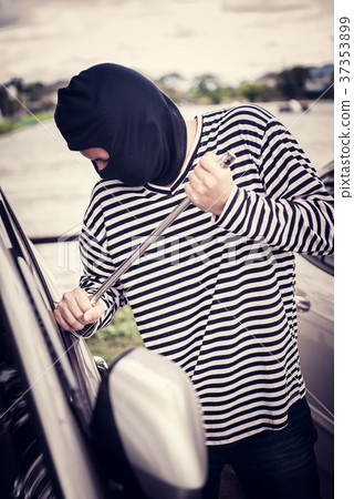 Thief is trying to steal the car at the parking 37353899
