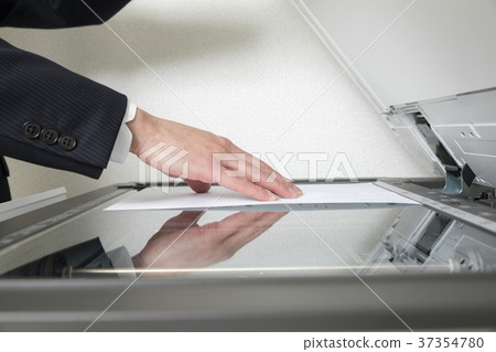Businessman hand using a copy machine 37354780