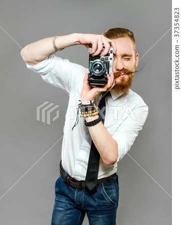 Stylish guy with a pipe reads old newspaper 37354823