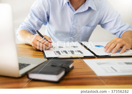 business men working on wooden desk(table) with notebook compute 37356282