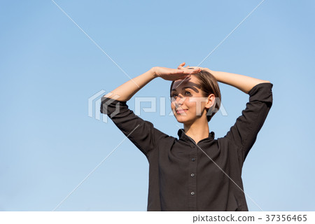 Young woman relaxing under the blue sky 37356465