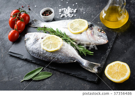 Uncooked sea bream fish, olive oil, lemon and 37356486
