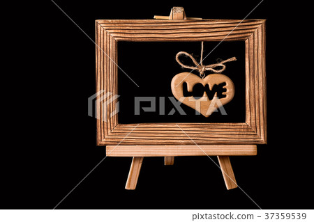 Heart hanging in old picture frame  on blac 37359539