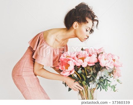 Beautiful woman with peonies 37360339