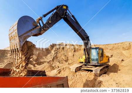 Excavator Loading Dumper Truck at sunny day 37362819