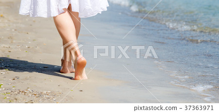 Beach travel - woman walking Beach travel - woman walking 37363971