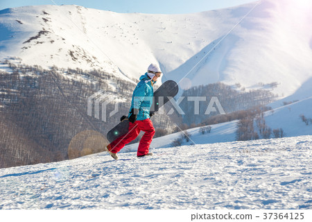 Young woman with snowboard 37364125