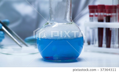 Chemical flask with blue boiling liquid standing Chemical flask with blue boiling liquid standing 37364311