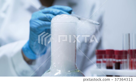 Bubbles trickling from chemical flask with acid Bubbles trickling from chemical flask with acid 37364313