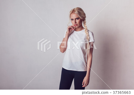 Beautiful girl with two braids in a white T-shirt Beautiful girl with two braids in a white T-shirt 37365663