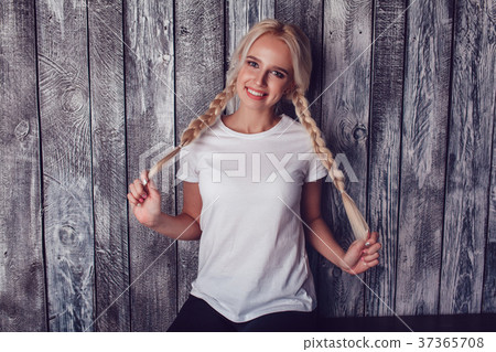 Beautiful girl with two braids in a white T-shirt 37365708