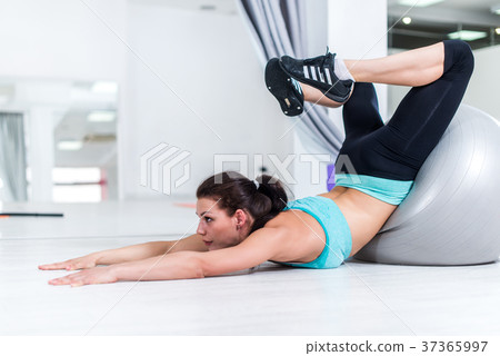 Young brunette stretching her back trying to reach 37365997