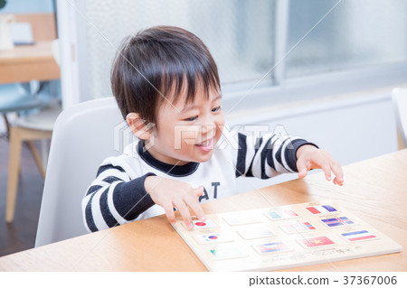 Toddler playing with national flag puzzle at dining table Toddler playing with national flag puzzle at dining table 37367006