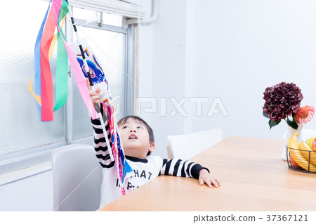 Toddler playing with a carp streamer 37367121