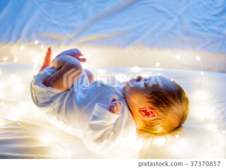 Little infant on white bed 37370857