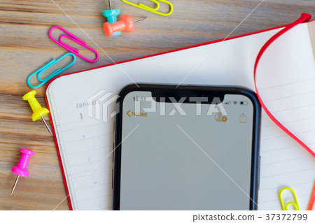 Close up of open notebook and phone Close up of open notebook and phone 37372799