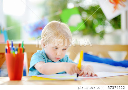 Cute little boy drawing and painting with colorful markers pens at kindergarten Cute little boy drawing and painting with colorful markers pens at kindergarten 37374222