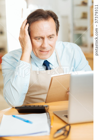 Occupied disappointed man sitting and overlooking Occupied disappointed man sitting and overlooking 37379311