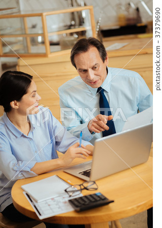 Smart nice-looking colleagues smiling and working 37379690