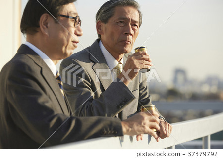 Businessman resting on the roof Businessman resting on the roof 37379792