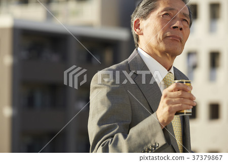 Businessman resting on the roof Businessman resting on the roof 37379867