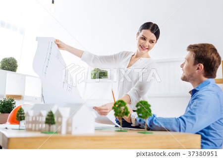 Happy engineer demonstrating her scheme to a 37380951