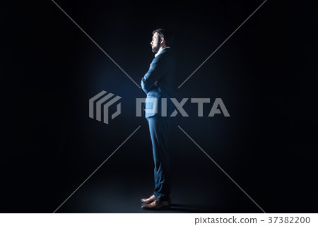 Good looking smart businessman looking in front of Good looking smart businessman looking in front of 37382200