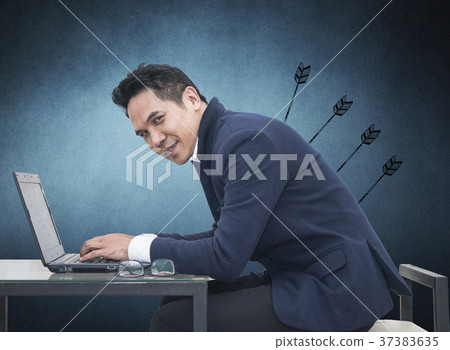 Portrait of young man sitting working on laptop 37383635