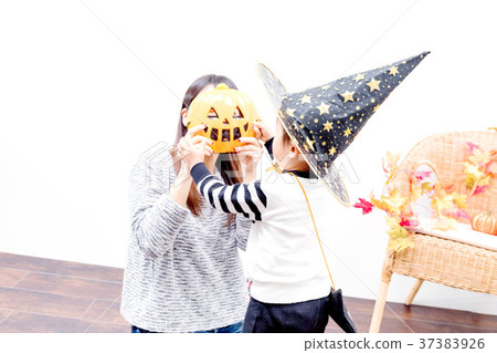 Toddlers and women playing with Halloween costumes 37383926